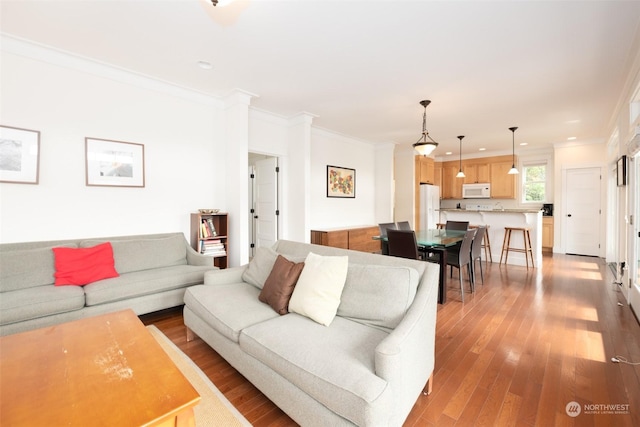 267 Compass St, Pacific Beach, WA 98571 - living room featuring wood finished floors, ornamental molding, and recessed lighting