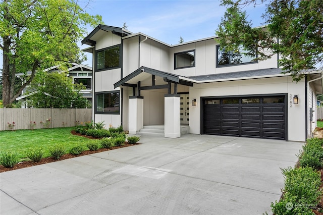 modern inspired farmhouse with a front lawn and a garage