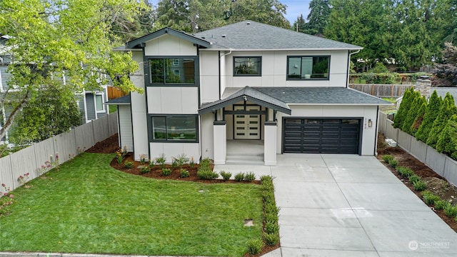 view of front facade with a garage and a front lawn