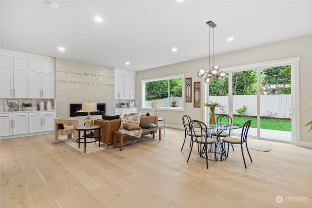 dining space featuring a chandelier, light hardwood / wood-style floors, and a wealth of natural light