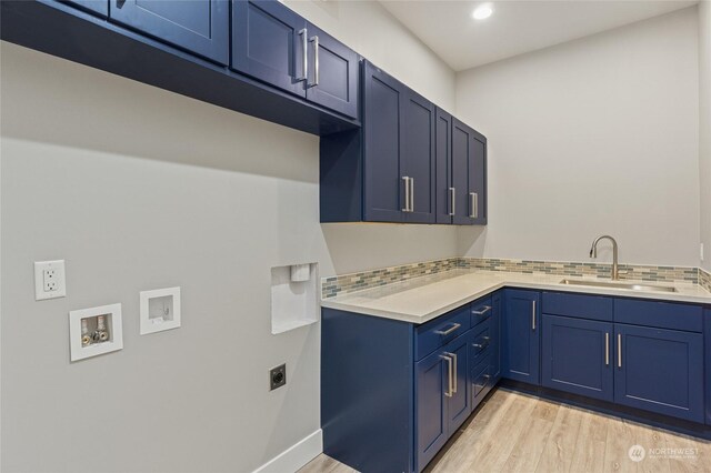 laundry area with cabinets, sink, electric dryer hookup, light hardwood / wood-style flooring, and hookup for a washing machine