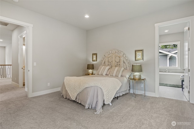 carpeted bedroom featuring ensuite bathroom