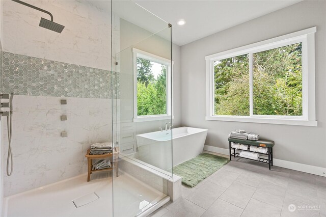 bathroom with independent shower and bath and tile patterned floors