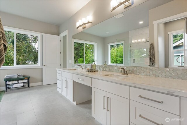 bathroom featuring walk in shower, vanity, and a wealth of natural light