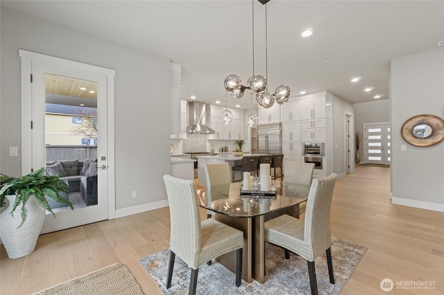 dining room featuring baseboards, recessed lighting, a notable chandelier, and light wood-style floors