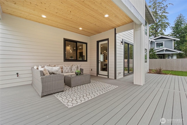 wooden deck with fence and outdoor lounge area