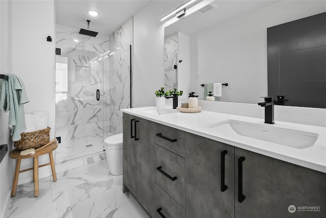 bathroom with a shower with door, vanity, and toilet