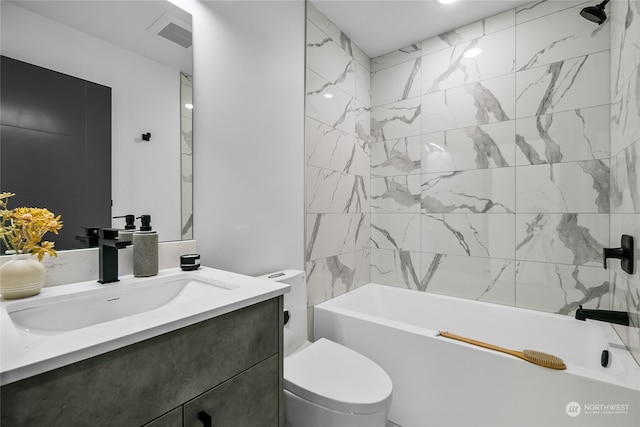 full bathroom with vanity, tiled shower / bath combo, and toilet