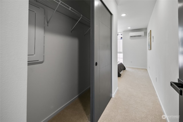 spacious closet with a wall unit AC and light colored carpet