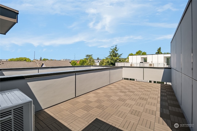 view of patio featuring ac unit and a balcony