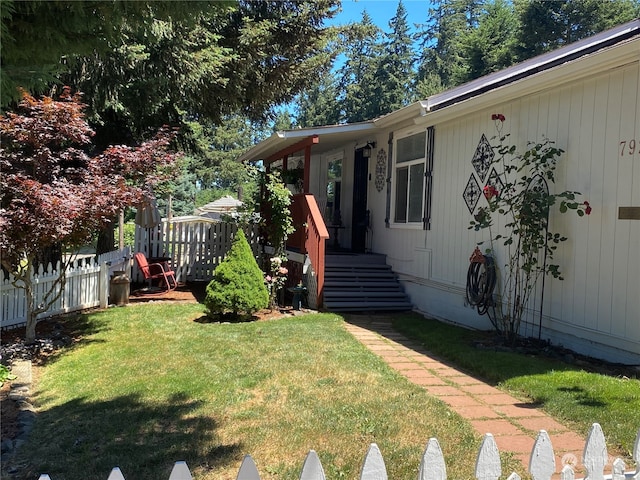 entrance to property featuring a yard