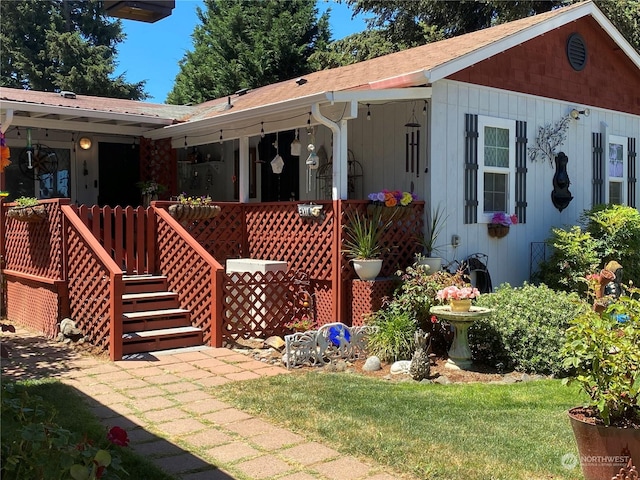 exterior space featuring covered porch and a front lawn