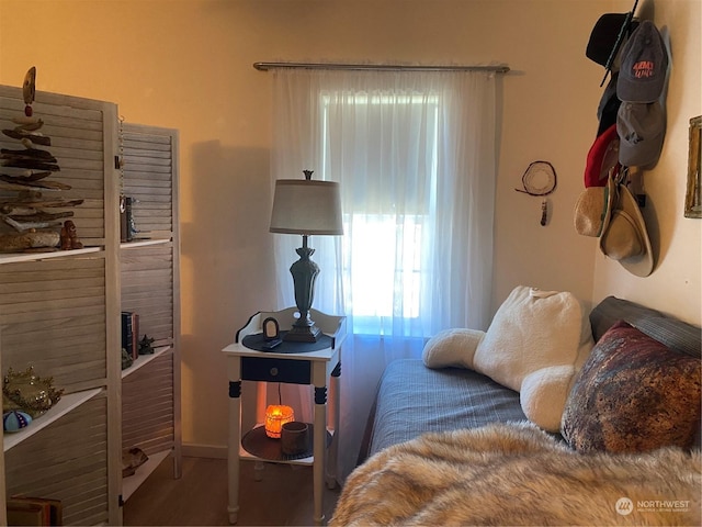 bedroom featuring wood finished floors and baseboards