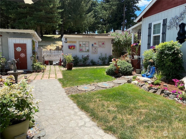 view of yard with an outdoor structure and fence
