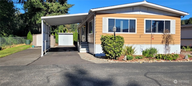 exterior space with a carport and a storage unit