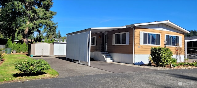 view of front of home featuring a storage unit