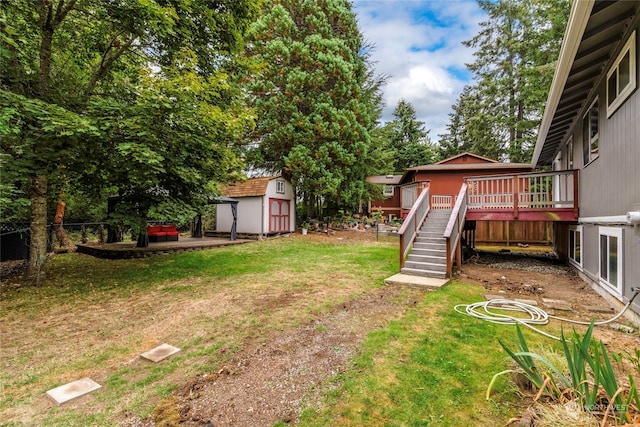 view of yard with a storage shed and a wooden deck