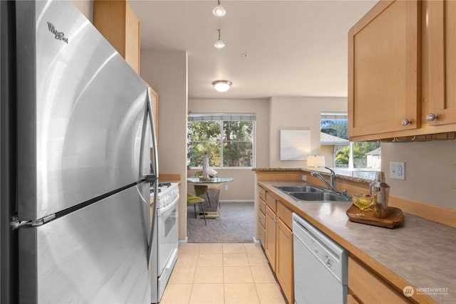 kitchen with light tile patterned floors, sink, and white appliances