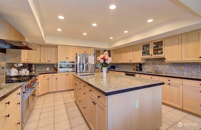 kitchen featuring light brown cabinets, sink, a center island with sink, and stainless steel appliances