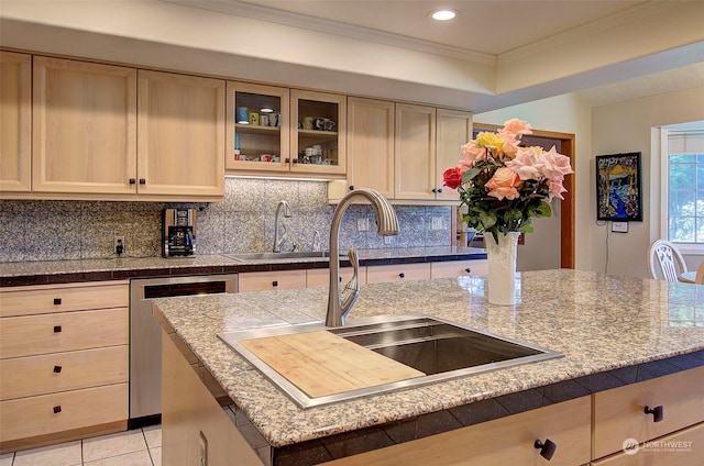 kitchen with an island with sink, sink, stainless steel dishwasher, crown molding, and decorative backsplash