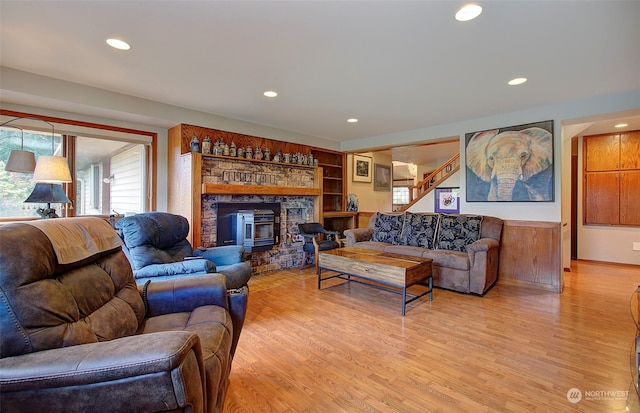 living room featuring light wood-type flooring and a fireplace