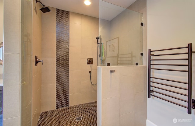 bathroom featuring a tile shower and radiator heating unit