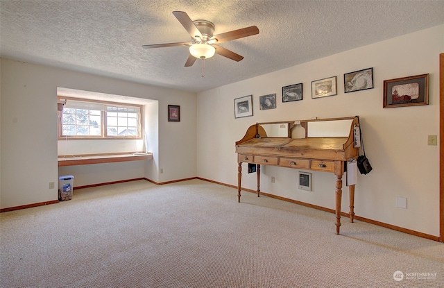 misc room with a textured ceiling, ceiling fan, and light colored carpet