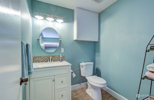 bathroom featuring hardwood / wood-style floors, vanity, and toilet