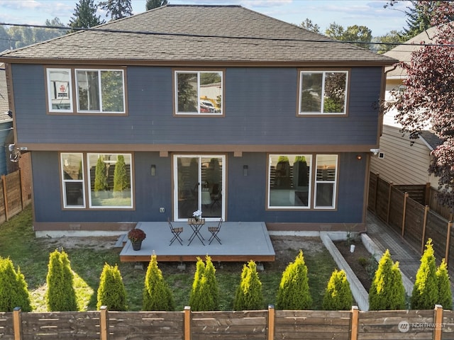 rear view of property with a wooden deck