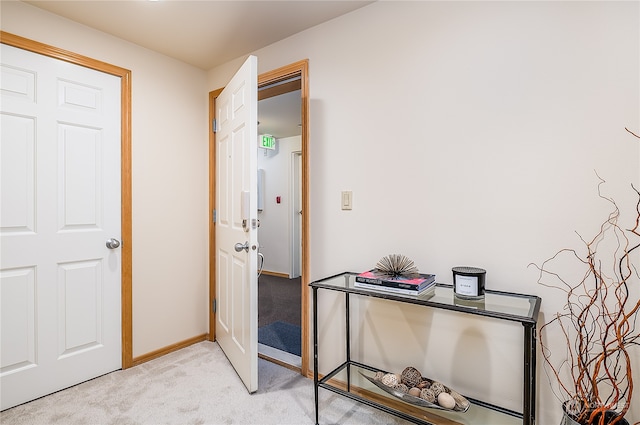 hall featuring light colored carpet