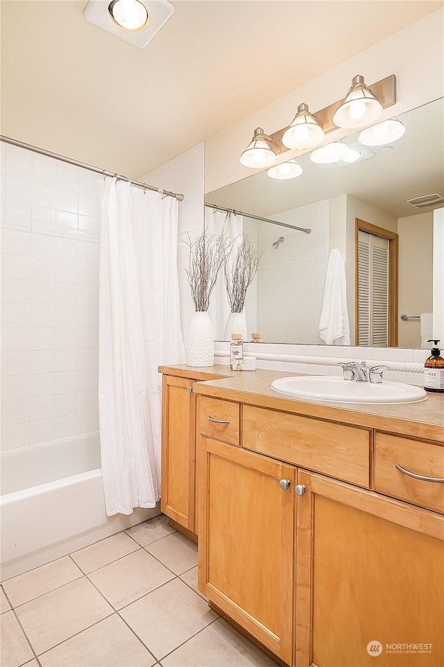 bathroom featuring tile patterned flooring, vanity, and shower / bath combo