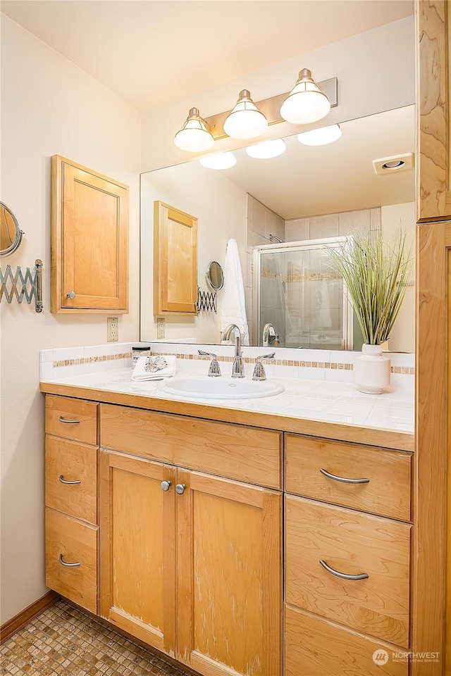 bathroom with vanity and walk in shower