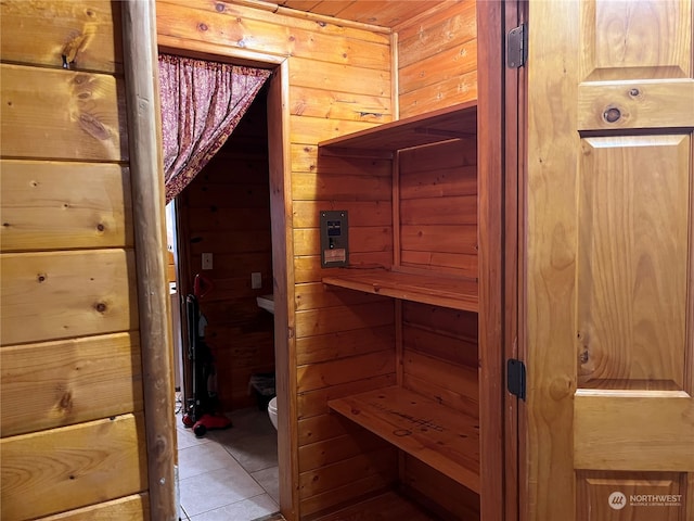 view of sauna / steam room featuring wooden walls and tile patterned flooring