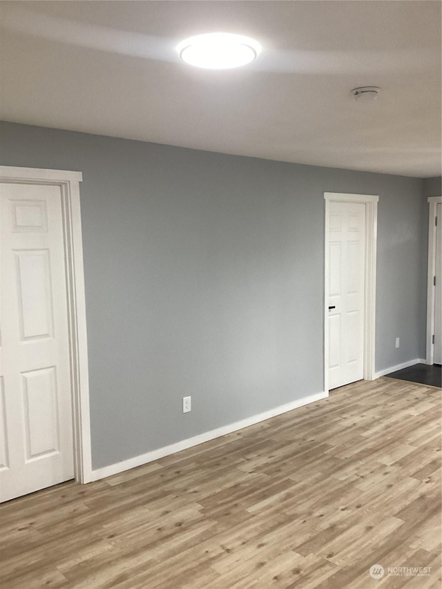 empty room with light hardwood / wood-style floors