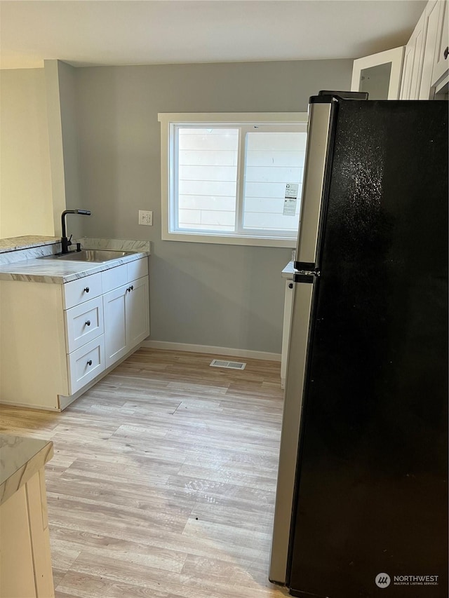 bathroom with hardwood / wood-style flooring and sink