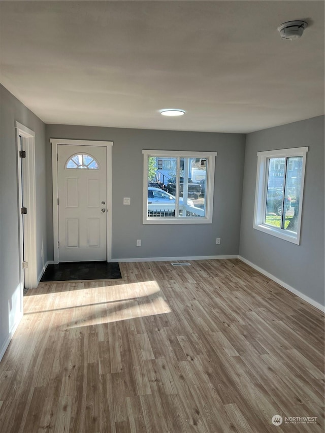 foyer entrance with light hardwood / wood-style flooring