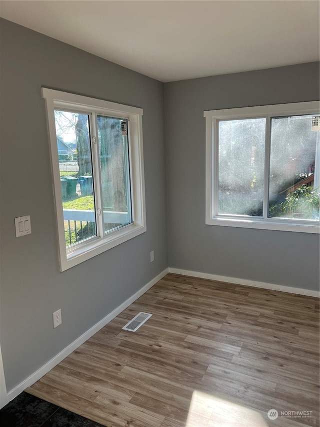 unfurnished room with light wood-type flooring