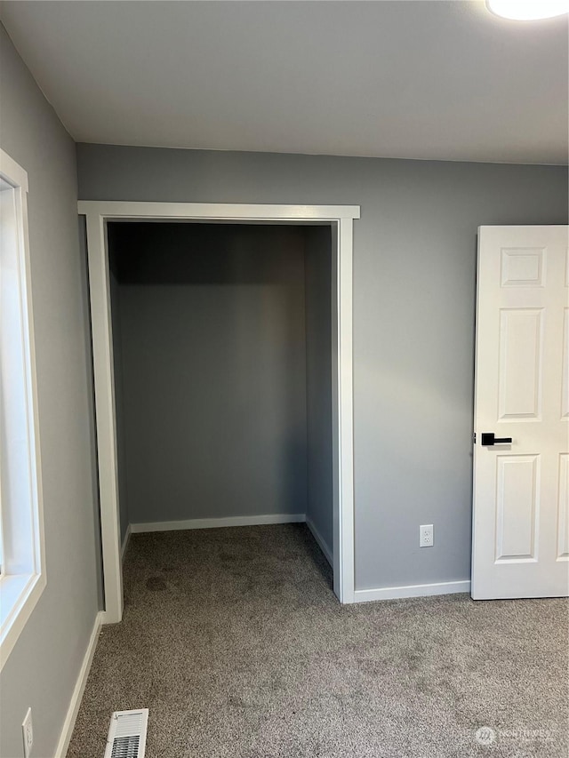 unfurnished bedroom with a closet and carpet