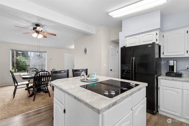 kitchen featuring white cabinetry, ceiling fan, dark hardwood / wood-style flooring, a kitchen island, and black appliances