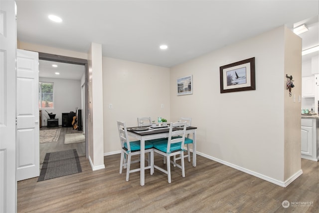 dining space featuring wood-type flooring