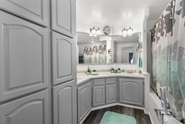 bathroom with shower / bath combo, vanity, and hardwood / wood-style flooring