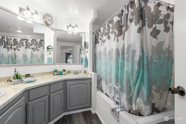 bathroom with vanity, wood-type flooring, and shower / tub combo with curtain