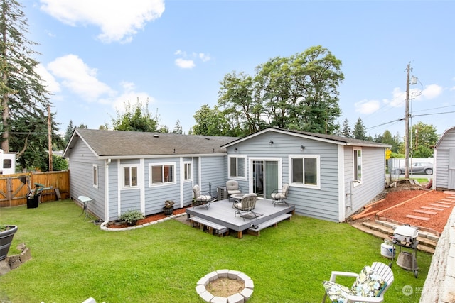 rear view of house with a yard and a wooden deck