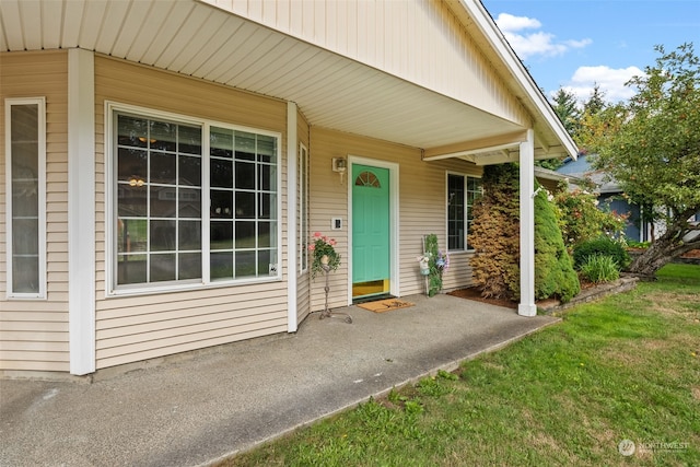 doorway to property featuring a lawn