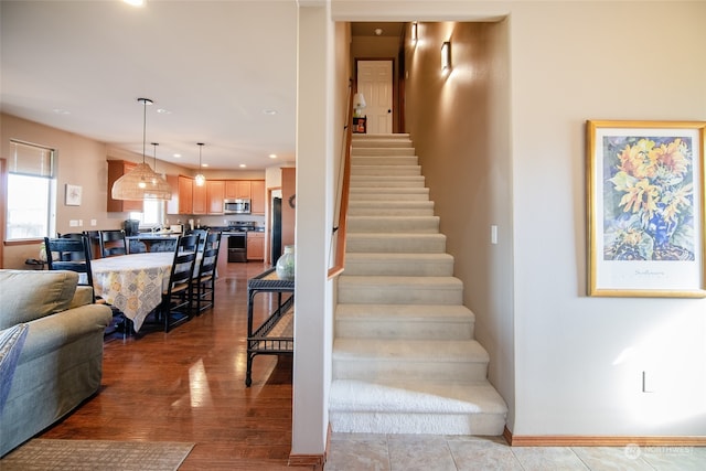 staircase with wood-type flooring