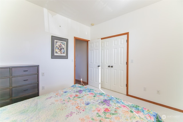 bedroom featuring light colored carpet and a closet