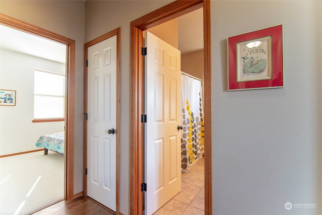 corridor with light tile patterned floors