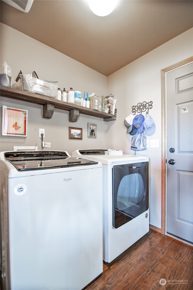 laundry area with dark wood-type flooring and washing machine and dryer