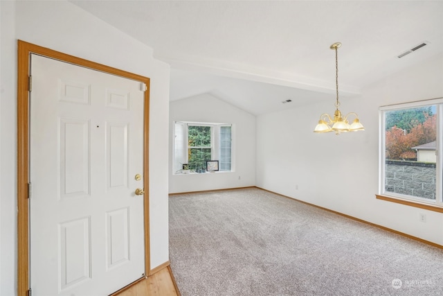 interior space with an inviting chandelier and vaulted ceiling