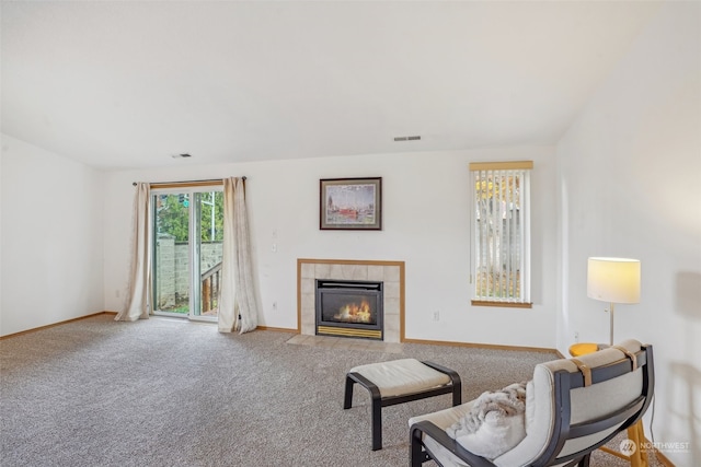 sitting room with a fireplace and carpet